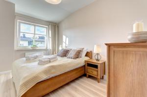 Łóżko lub łóżka w pokoju w obiekcie Dom & House - Apartments Parkur Sopot