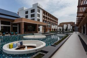 a hotel with a pool in front of a building at Laguna Grand Hotel & Spa Songkhla in Songkhla