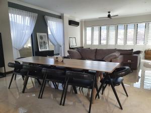 a living room with a table and a couch at Best of Both in Pecanwood Estate in Hartbeespoort