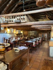 a restaurant with wooden tables and chairs in a room at Garni degli Angioli in Ascona