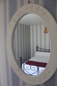a mirror in a room with a bed in it at Villa du Bac in Chambon-sur-Lac