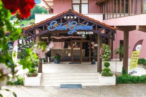 a restaurant with a sign on the front of a building at Hotel Eden Garden Spa in Câmpulung Moldovenesc