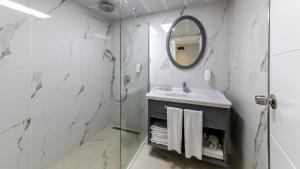 
a bathroom with a sink and a mirror at Motto Premium Hotel&Spa in Marmaris

