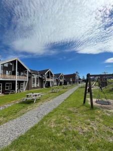 a park with picnic tables and a playground at Trysilfjell Apartment Hotel in Trysil