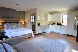 a large bedroom with a bed and a kitchen at Garden View Executive Suite in Johannesburg