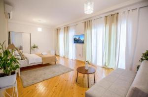 a living room with a bed and a couch at Meidan View in Tbilisi City