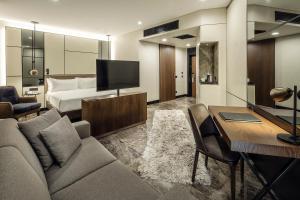 a living room with a couch and a bed at Dedeman Kartepe Kocaeli in Kocaeli