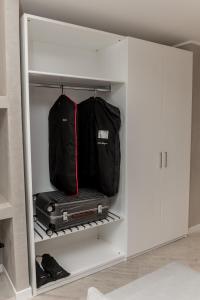 a suitcase and a bag in a white closet at EUROPA Hotel in Vasto