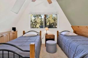 two beds in a room with a window at The Pyramid In Big Bear #2124 by Big Bear Vacations in Big Bear City