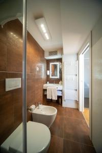 a bathroom with a sink and a toilet and a mirror at Padova Suites C20 in Padova