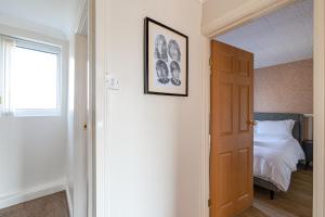 a room with a bedroom with a bed and a window at George Harrison's Former 3Bed Home in Liverpool in Speke +24 photos
