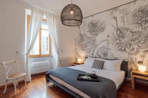 a bedroom with a bed with a flower mural on the wall at Urban Oasis - by MyHomeInComo in Como