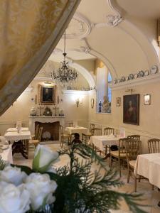 a dining room with tables and chairs and a fireplace at Ai Savoia B&B - Guest House in Turin