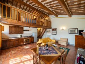 a living room with a table and a kitchen at Villa Borgo San Pietro in Cortona