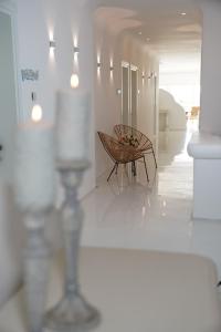 a hallway with two chairs and a table in a room at Yasos By The Sea in Çeşme