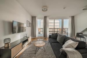 a living room with a couch and a tv at Liv's place in Vienna