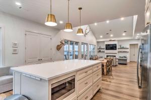 a kitchen with a white counter top and a living room at Modern Lake House on Lake Bruin Pier and Boat Slip! 