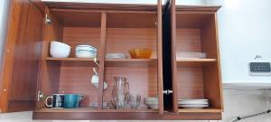 a wooden cabinet with plates and dishes in it at Stone House - Sintra Rural in Sintra