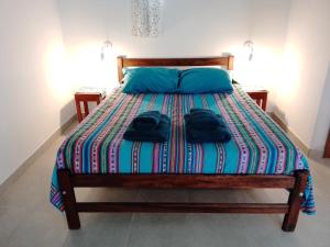 a bedroom with a bed with two towels on it at El Cardón,monoambiente en el campo in Humahuaca