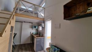 a room with a loft bed and a kitchen at Family Surf Home - Casa do Páteo 5 in Santo Isidoro