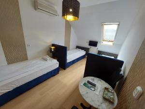 A bed or beds in a room at Palma Vendégház