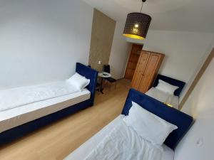 A bed or beds in a room at Palma Vendégház