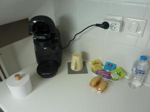 a coffee maker sitting on a counter with food and drinks at Etage privatif in Tarbes