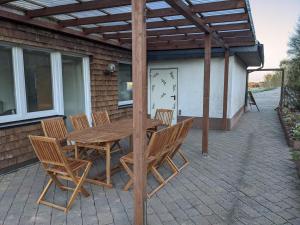 a wooden table and chairs on a patio at Haus Eisfenn in Blankenheim