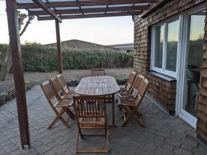 a wooden table and chairs on a patio at Haus Eisfenn in Blankenheim