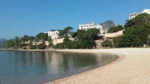 a beach with buildings on a hill next to the water at B&B Sa Madalena a Dorgali-IUN E4918 in Dorgali