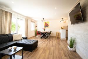a living room with a couch and a table at BUKY HOUSE in Sumartin