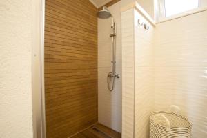 a shower stall in a bathroom with wooden walls at BUKY HOUSE in Sumartin +30 photos