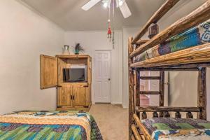 a bedroom with two bunk beds and a tv at Cozy Cloudcroft Cabin with Deck and Gas Grill! in Cloudcroft +25 photos