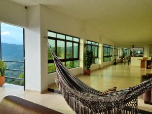 a swinging hammock in a room with a view at Casa campestre Finca la Roca in La Mesa