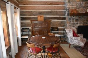 a dining room with a wooden table and chairs at Altamont Lodge in Newland