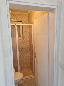 een badkamer met een toilet en een douche bij NJEGUSI OASIS - a place to charge your batteries! in Njeguši