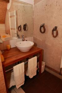 a bathroom with a white sink and a mirror at Chambre d'hôtes du Moulin de Landonvillers in Courcelles-Chaussy