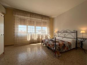a bedroom with a bed and a large window at Appartamenti Villacedro in Lazise +51 photos