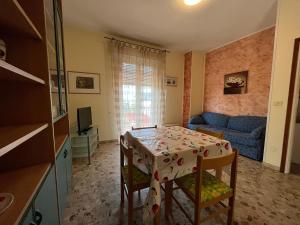 a living room with a table and a blue couch at Appartamenti Villacedro in Lazise