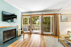 a living room with a fireplace and a television at Seagrove 5-A in Isle of Palms