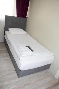 a bed in a room with a white mattress at palmiye suıt otel in Istanbul