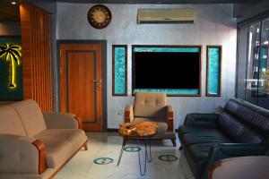 a living room with a couch and a table at Palmiye Suite Hotel Bakirkoy City Center in Istanbul