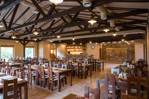 a dining room with wooden tables and chairs at Camping Bartbo in Olsztyn