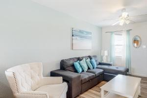 a living room with a couch and a chair at Sunrise Village #209 in Gulf Shores
