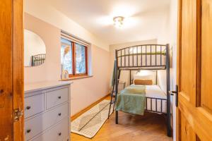 a bedroom with a bed and a desk at Glan Morfa Lodge & Wildlife Experience in Dwyran