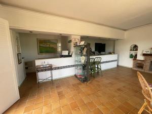 a living room with a counter and chairs and a table at Hotel La Peña in Tarifa