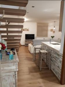 a living room with a kitchen and a living room with a stair at Casa Miguel in Montejaque