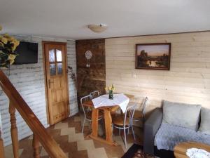 a dining room with a table and a couch at Domek u Doroty Orelec k Soliny in Orelec