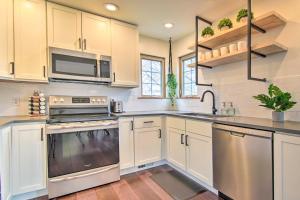 a kitchen with white cabinets and stainless steel appliances at Modern Lake Geneva Home - 1 Mi to Boat Launch in Lake Geneva