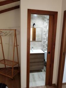 a bathroom with a sink and a mirror and a ladder at Casa Miguel in Montejaque